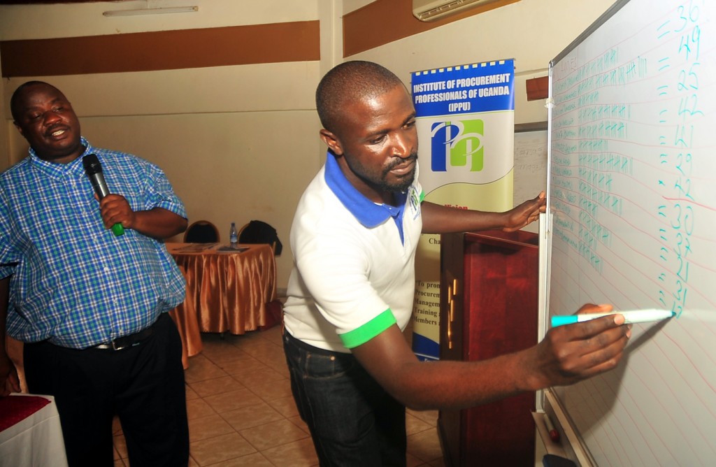 CAPTION Ministry of Finance Planning and Economic Development, procurement specialist Patrick Kagaba (L) with IPPU, admistrative officer, Julius Tugume (R) preside over election of IPPU council during annual general meeting at Fairway Hotel on Saturday. (PHOTO: STEPHEN WANDERA)
