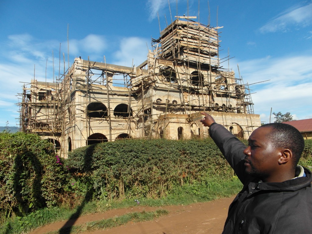 Christian points at Kabaale church building