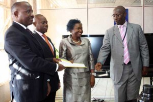 breaker02px Ready for business: (Left to right) Centenary bank MD Fabian Kasi, dfcu MD Juma Kisaame, Finance Minister Maria Kiwanuka, and Stanbic bank MD Philip Odera after the signing of the MoU. Photo by Faiswal Kasirye.