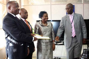 Ready for business: (Left to right) Centenary bank MD Fabian Kasi, dfcu MD Juma Kisaame, Finance Minister Maria Kiwanuka, and Stanbic bank MD Philip Odera after the signing of the MoU. Photo by Faiswal Kasirye.